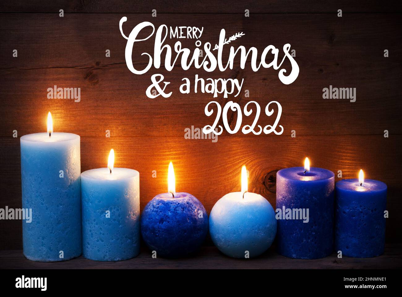 Candlight Christmas 2022 English Calligraphy Merry Christmas And Happy 2022. Turquoise Romantic Candle  Light With Brown Wooden Background Stock Photo - Alamy