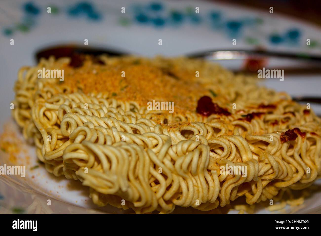 Eating unhealthy late at night. Prepare instant noodle soup with sauce
