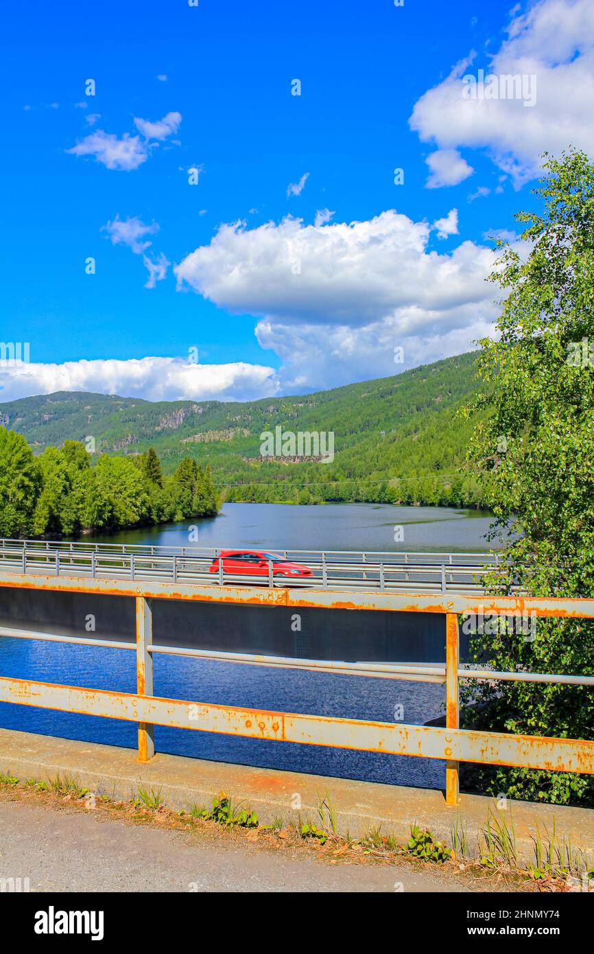 Car drives on bridge over a river, beautiful Norway landscape. Stock Photo