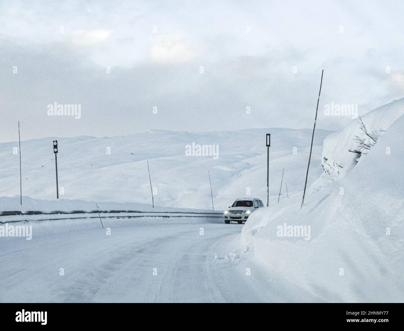 Driving through snowy road and landscape in Norway. Stock Photo