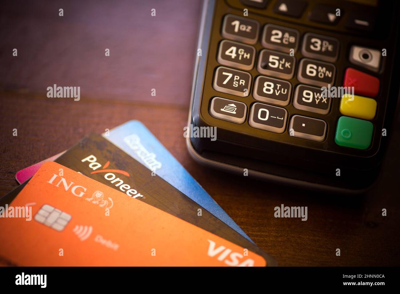 Revolut, ING and Payoneer cards near a POS terminal Stock Photo