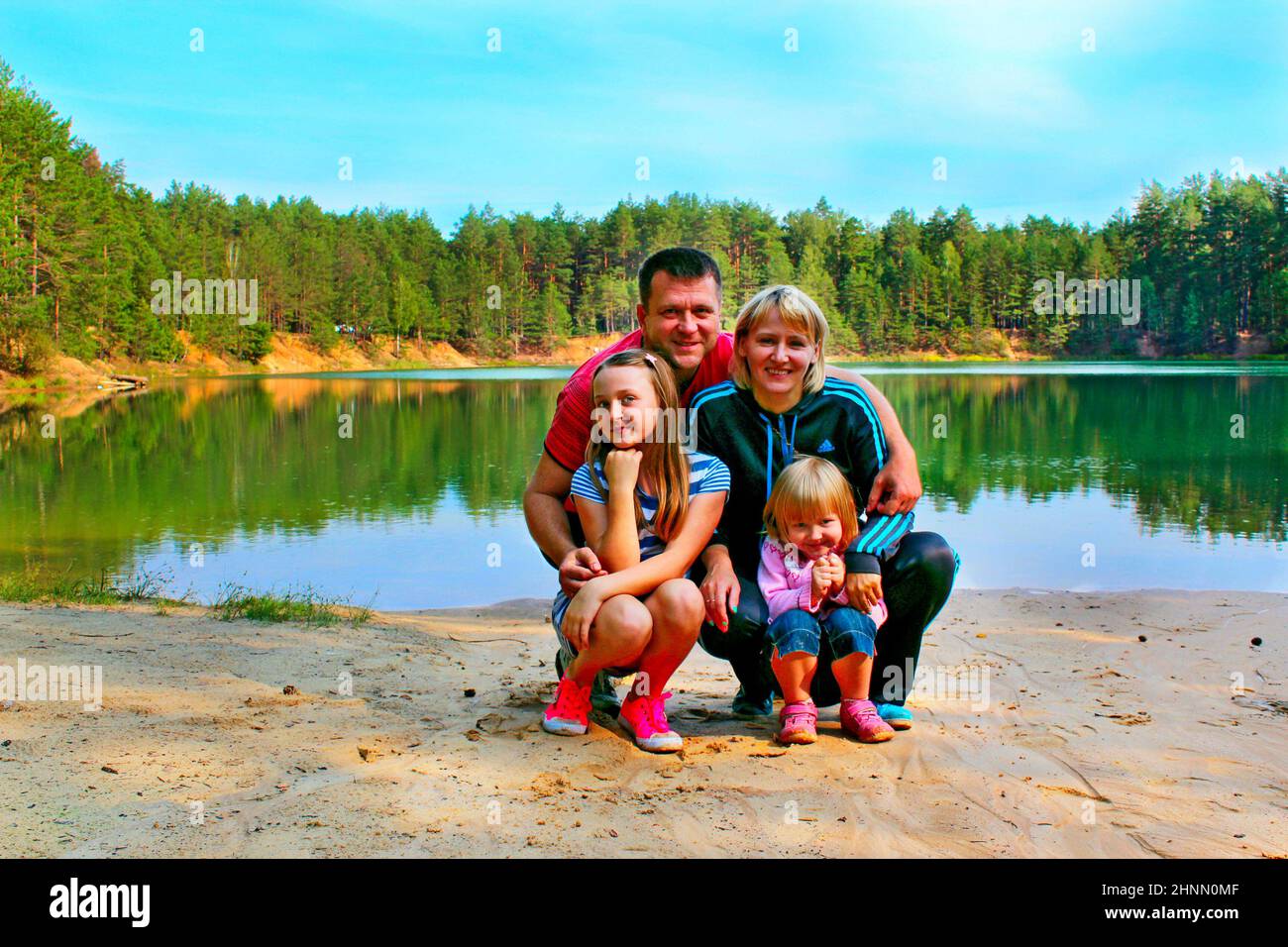 Family vacation near forest lake. Father mother and children Stock Photo