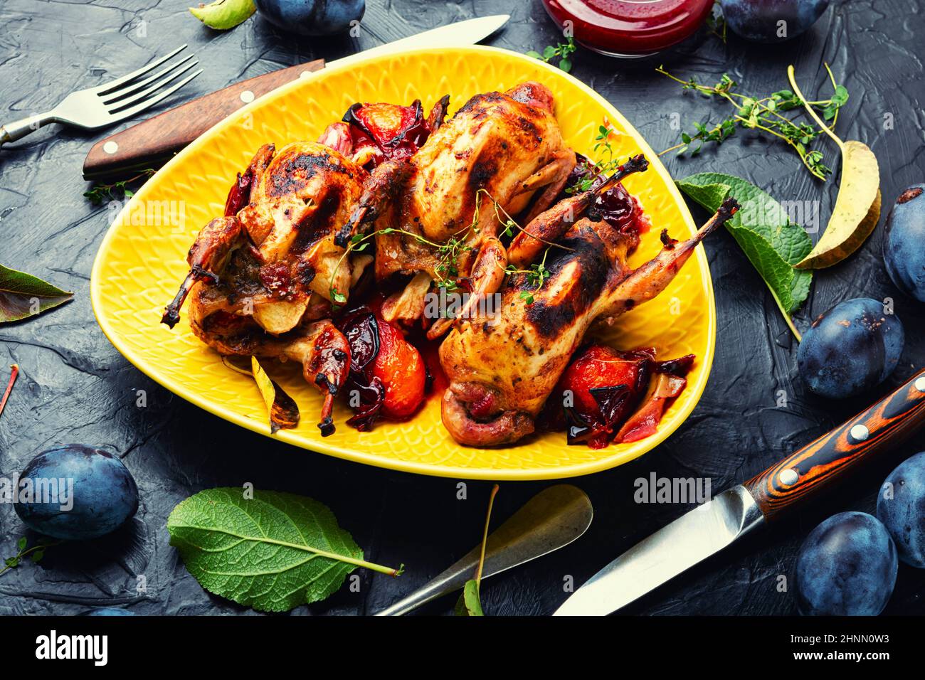 Fried quail in plum sauce. Meat with plum Stock Photo Alamy