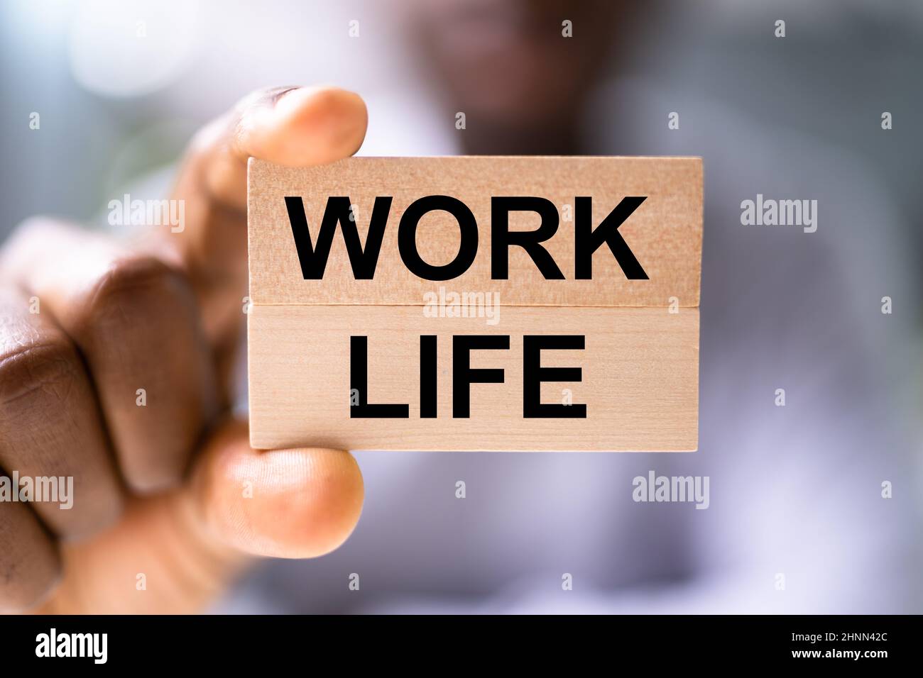 African American Man Holding Work Life Balance Blocks Stock Photo - Alamy