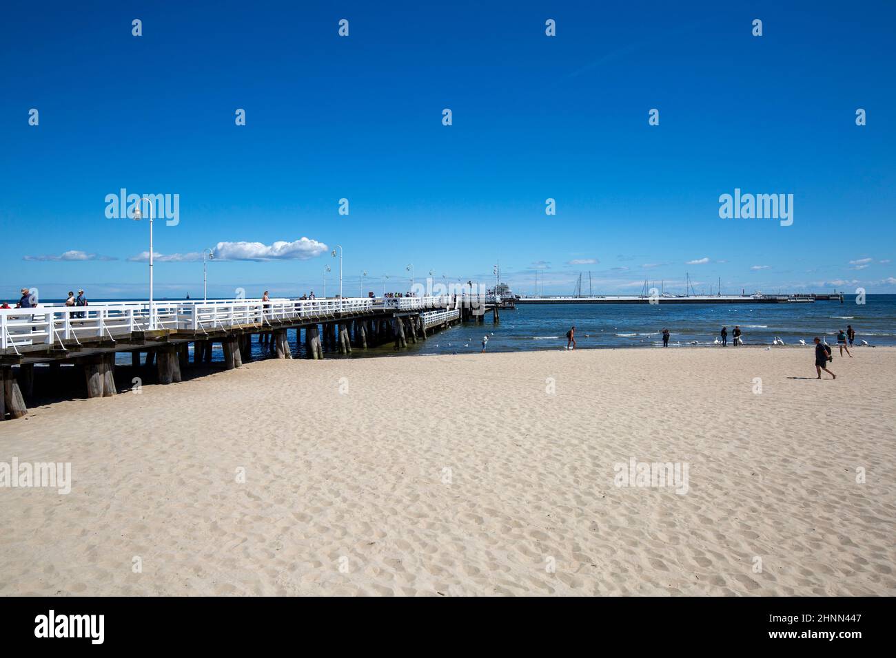 Wooden Sopot pier in sunny day, view from the sandy beach, Sopot, Poland Stock Photo