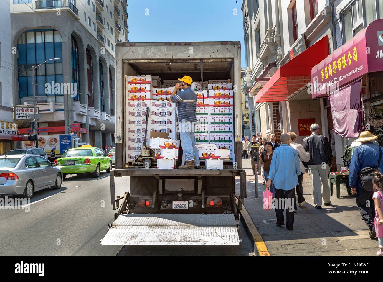 a man with truck delivers fresh fruits to chinese restaurants in Chinatown, San Francisco, USA Stock Photo