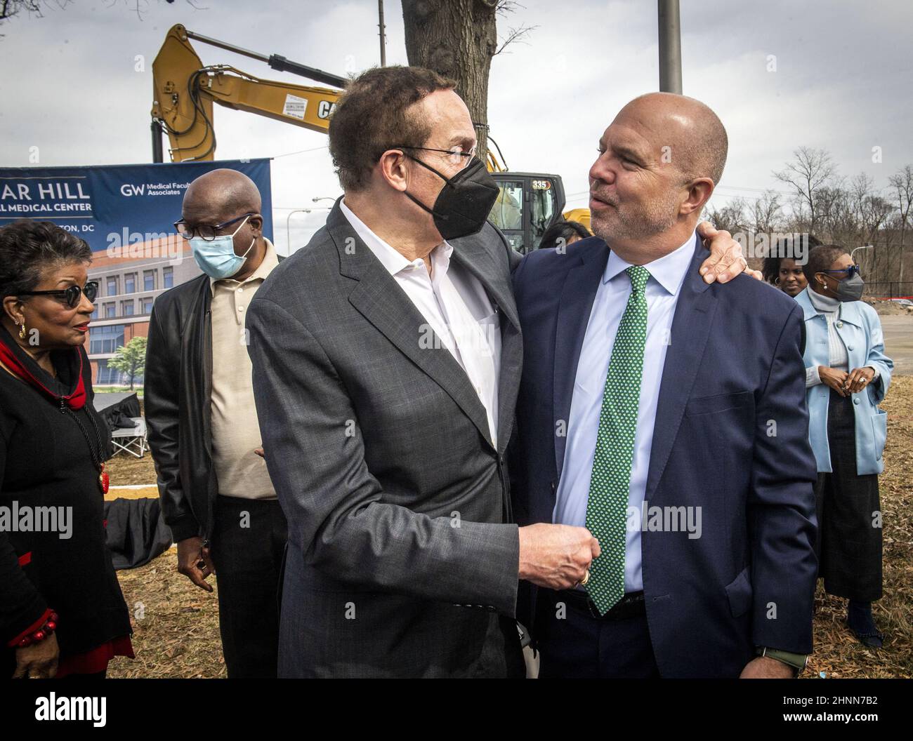 Washington, United States. 17th Feb, 2022. WASHINGTON, DC - FEBRUARY 17: Former council person David Catania, right, greets former Mayor Vincent Gray before Mayor Muriel Bowser, Universal Health Services, George Washington University, Children's National Hospital, and other honored guests gather at the groundbreaking and name reveal of the New Hospital at St Elizabeths East Campus in Washington, DC. At far left is Cora Master Barry, widow of the late Mayor Barry. (Photo by Bill O'Leary/The Washington Post) Credit: UPI/Alamy Live News Stock Photo