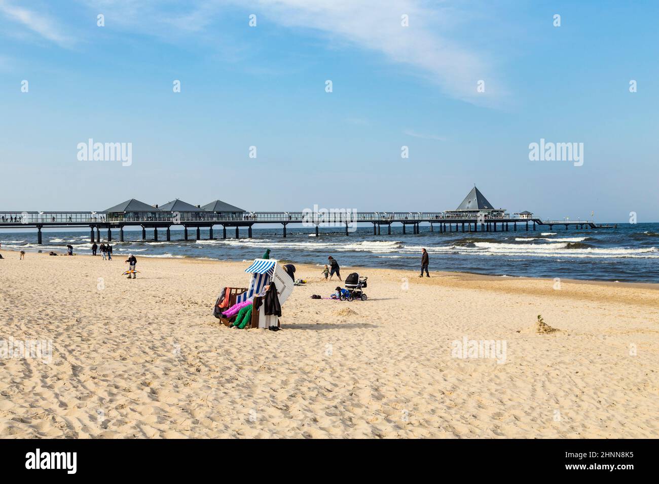 people enjoy pier and beach of Ahlbeck Stock Photo