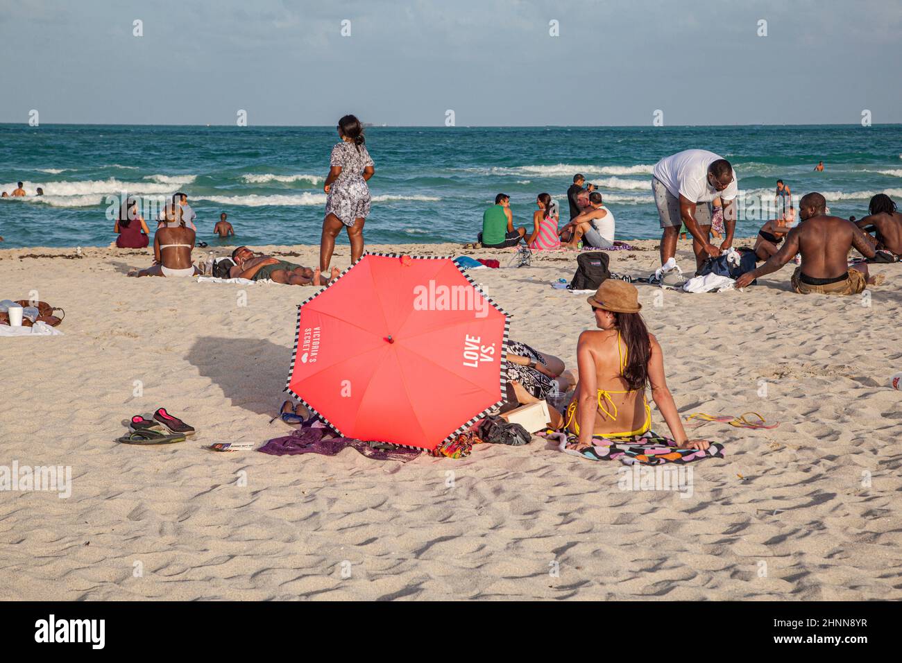 people enjoy the famous south beach in Miami Beach and relax in afternoon sun Stock Photo