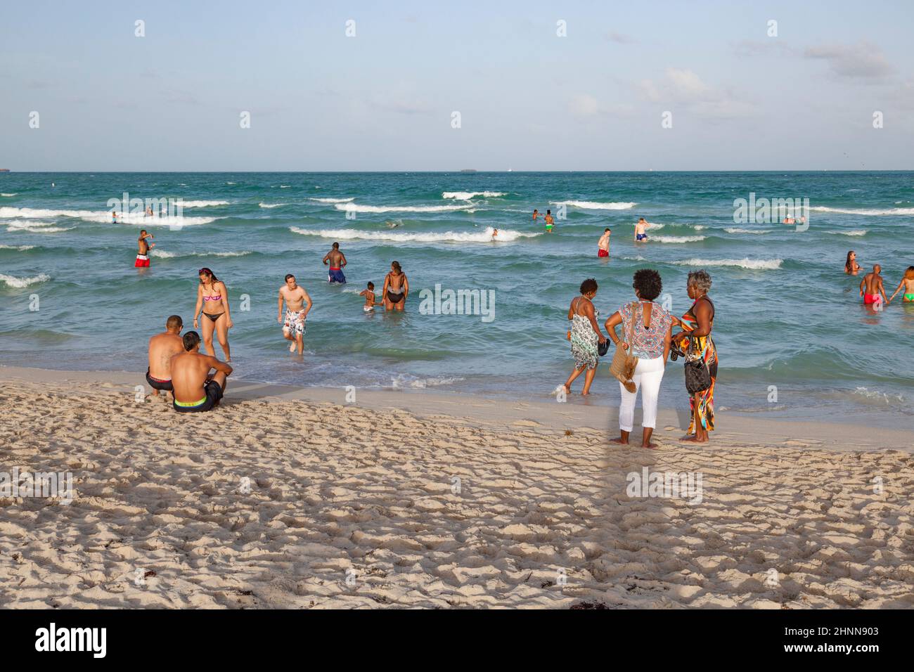people enjoy the famous south beach in Miami Beach and relax in afternoon sun Stock Photo