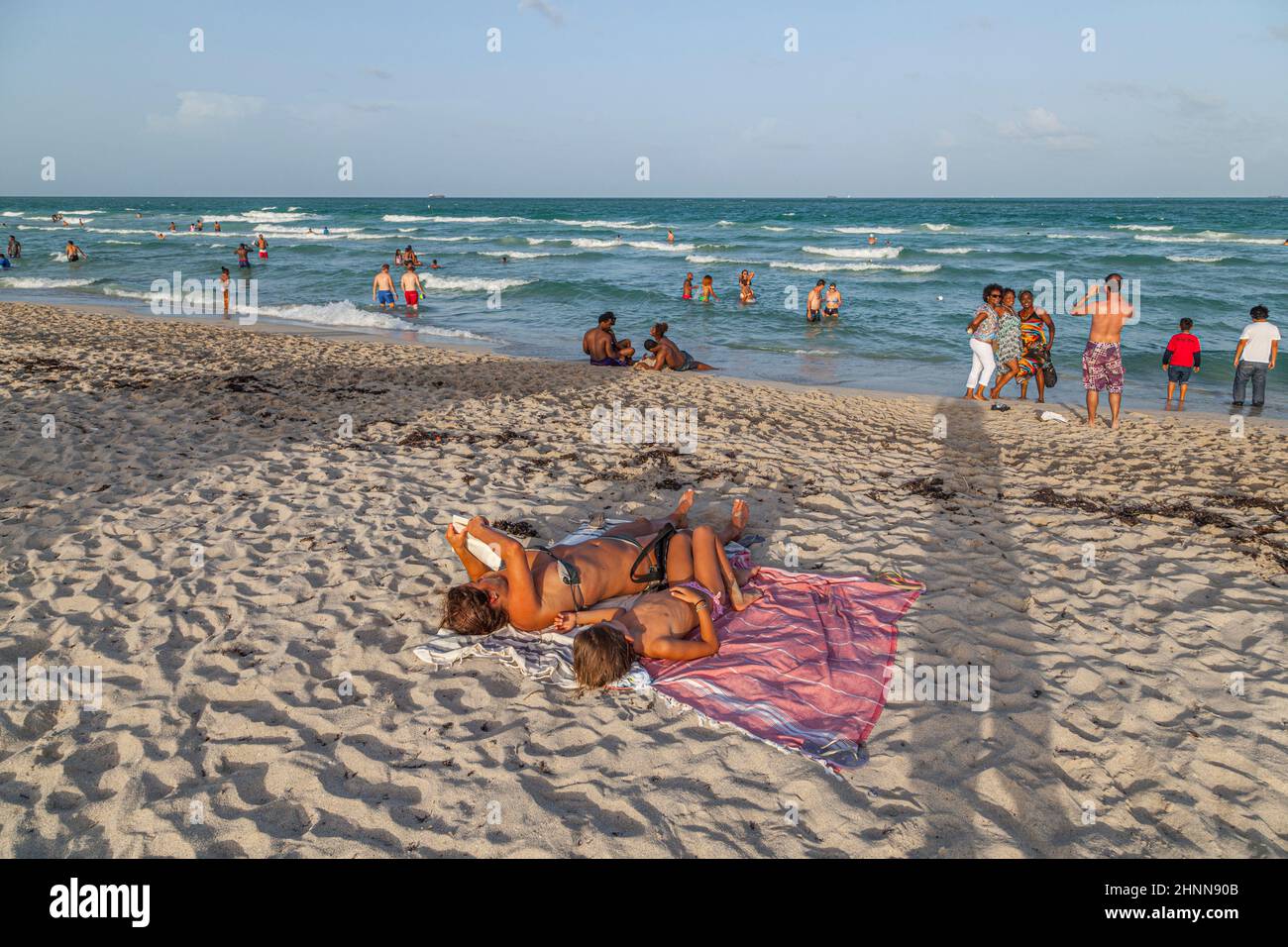 people enjoy the famous south beach sunset in Miami Beach and relax in afternoon sun Stock Photo