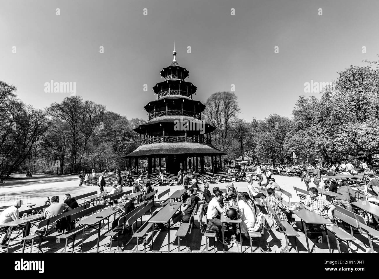 people enjoy the  Biergarten near Chinese tower Stock Photo