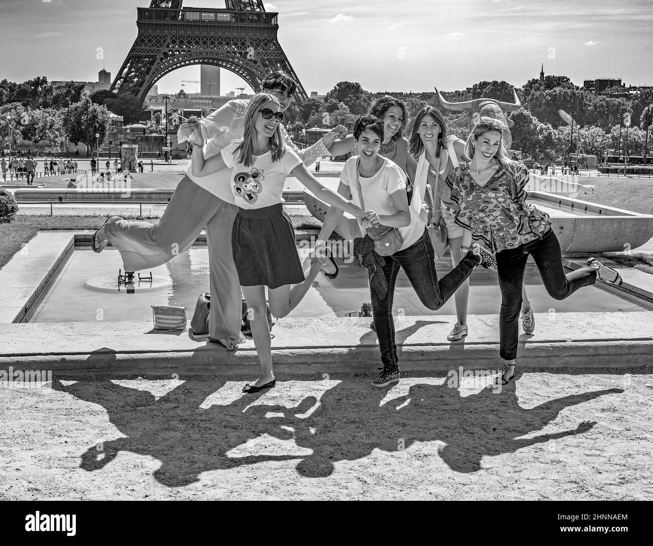 Tourists pose in front of Eiffel Tower in Paris, France Stock Photo
