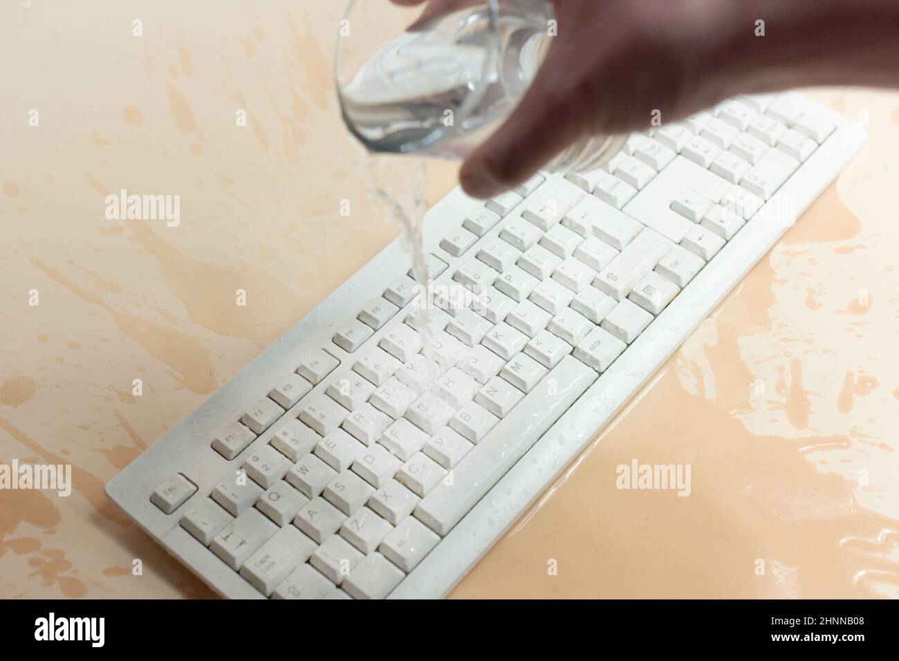 Keyboard in the water, waterproof keyboard, spilled water on the computer.  I flooded the keyboard with liquid, what to do Stock Photo - Alamy