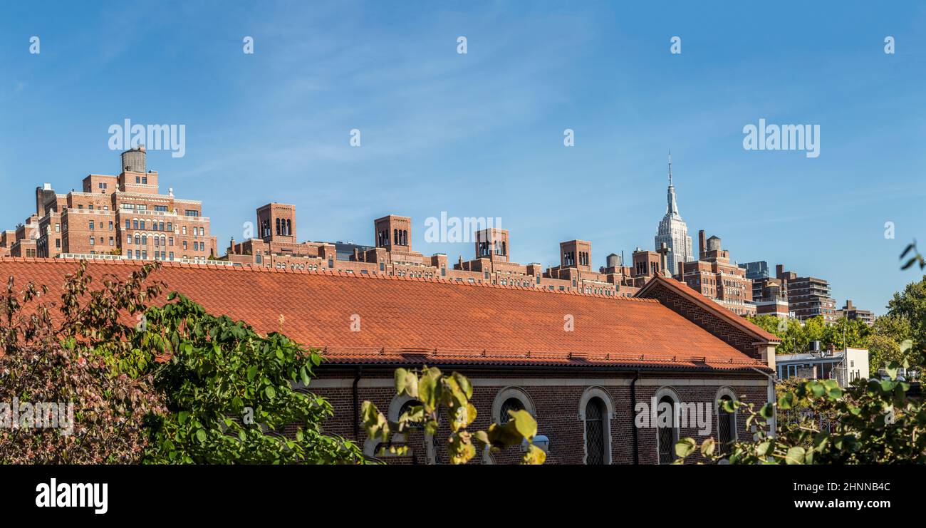 skyline of New York city seen from the lower west side with typical red brick buildings and view to empire state building in New York, USA. Stock Photo