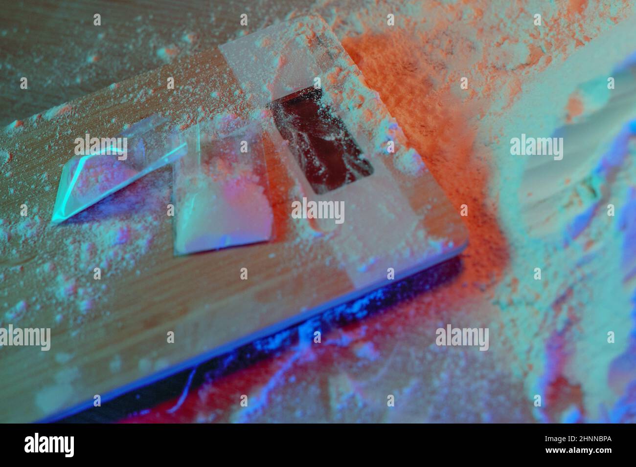 Drugs, drug dealer's house. Cocaine packaged in sachets, scales tablets and syringes in neon