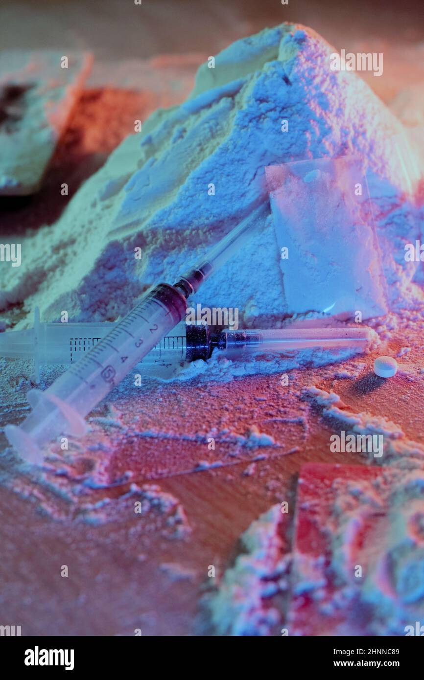 Drugs, drug dealer's house. Cocaine packaged in sachets, scales tablets and syringes in neon