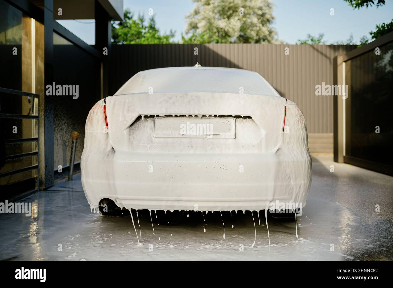 Cleaning foam on the car, hand car wash station, nobody. Carwash