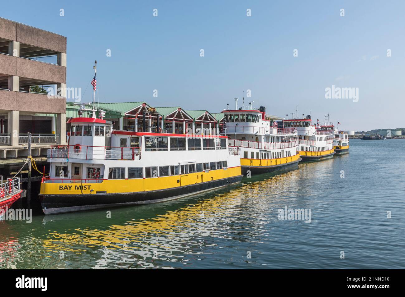 old wharf area in Portland with motorboats and old halls from fishing industry Stock Photo