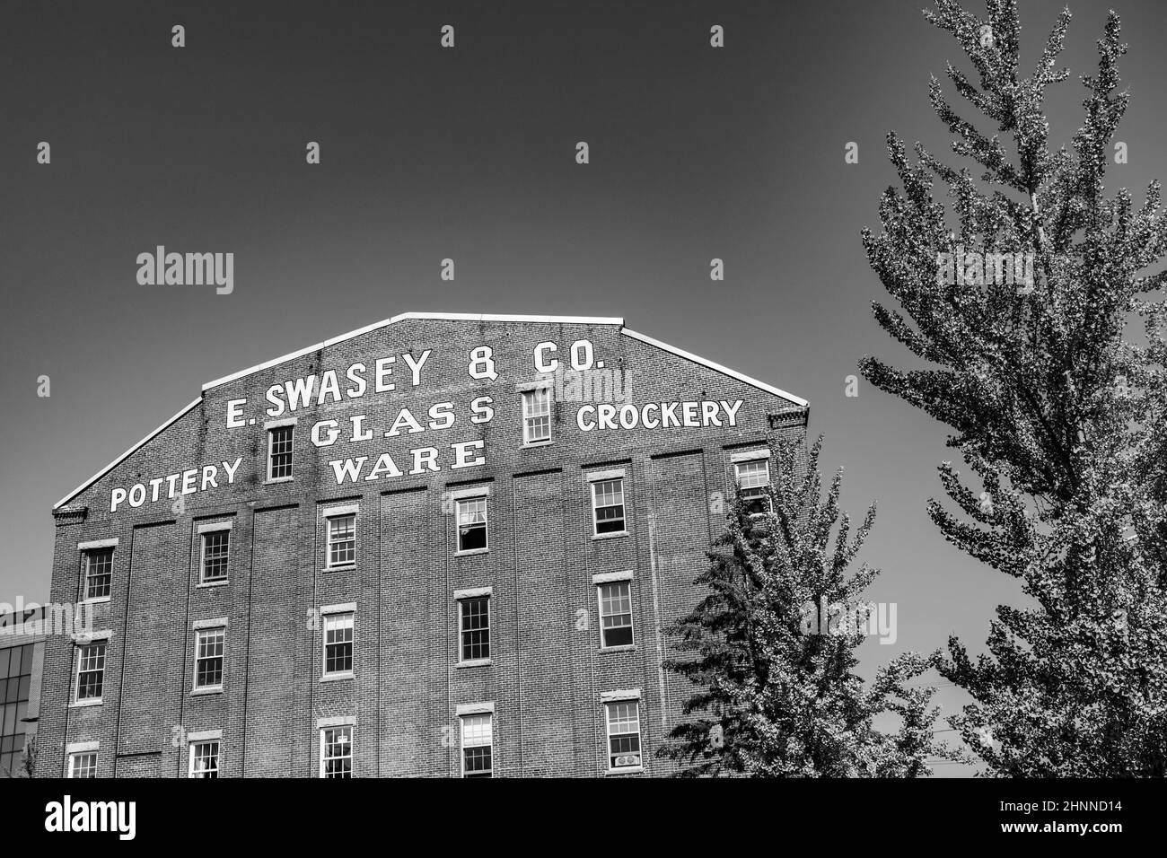 facade of historic brick building with advertising for Swasey Pottery, Glassware and Crockery in Portland, Maine, USA Stock Photo