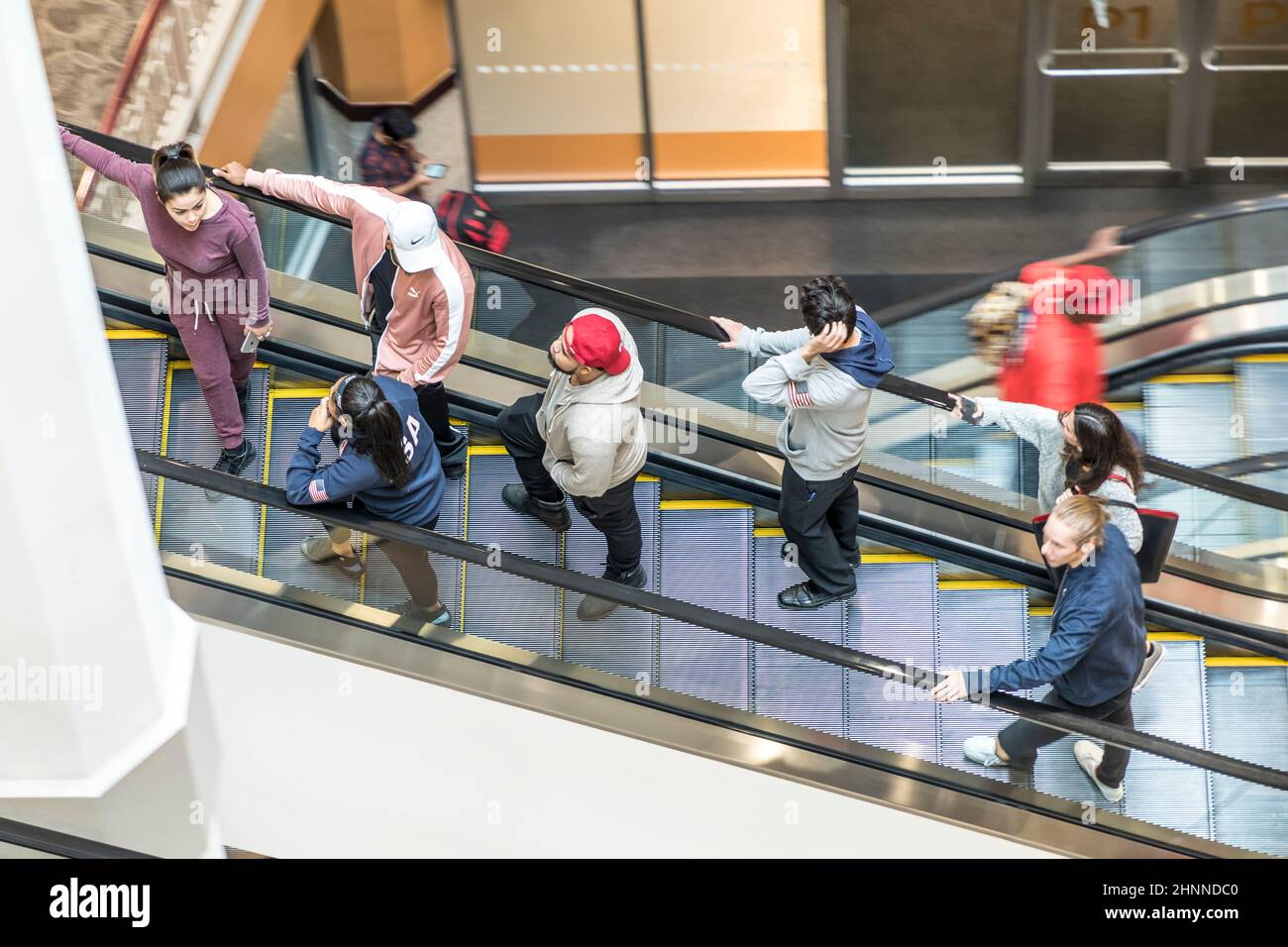 people at a rolling escalator in the shopping center Providence Place in Providence, USA Stock Photo