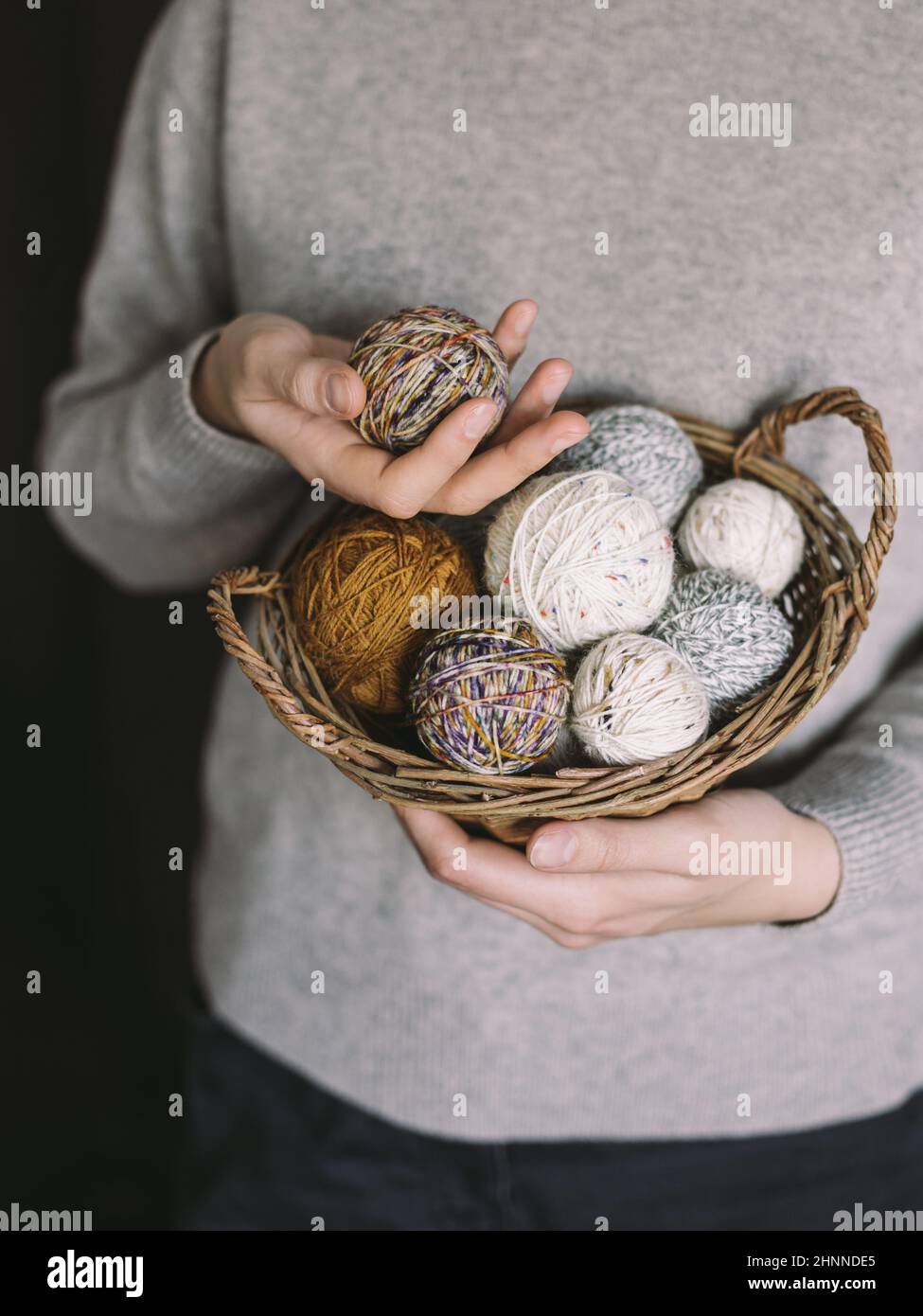 Basket with balls of yarn in a women hands. Concept for handmade and ...
