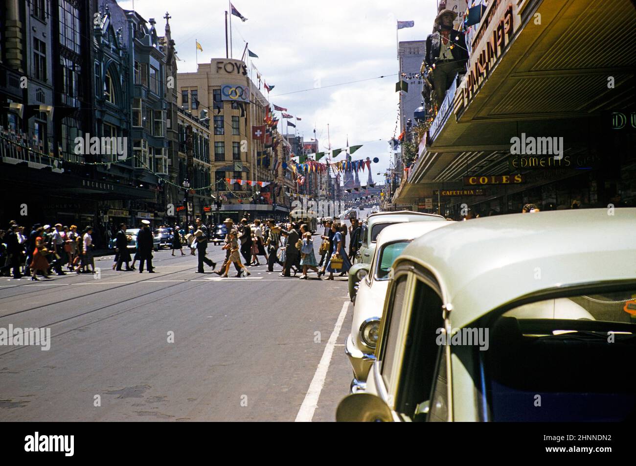 Shops and crowds of shoppers in city centre, Elizabeth Street, Melbourne, Victoria, Australia 1956 - Coles and Foys department stores Stock Photo