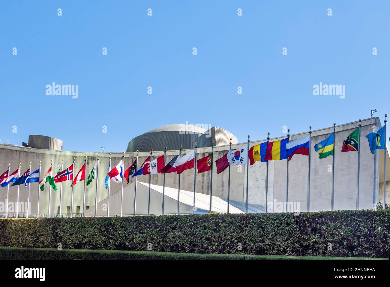 UN Nations building with flags of participating countries in afternoon