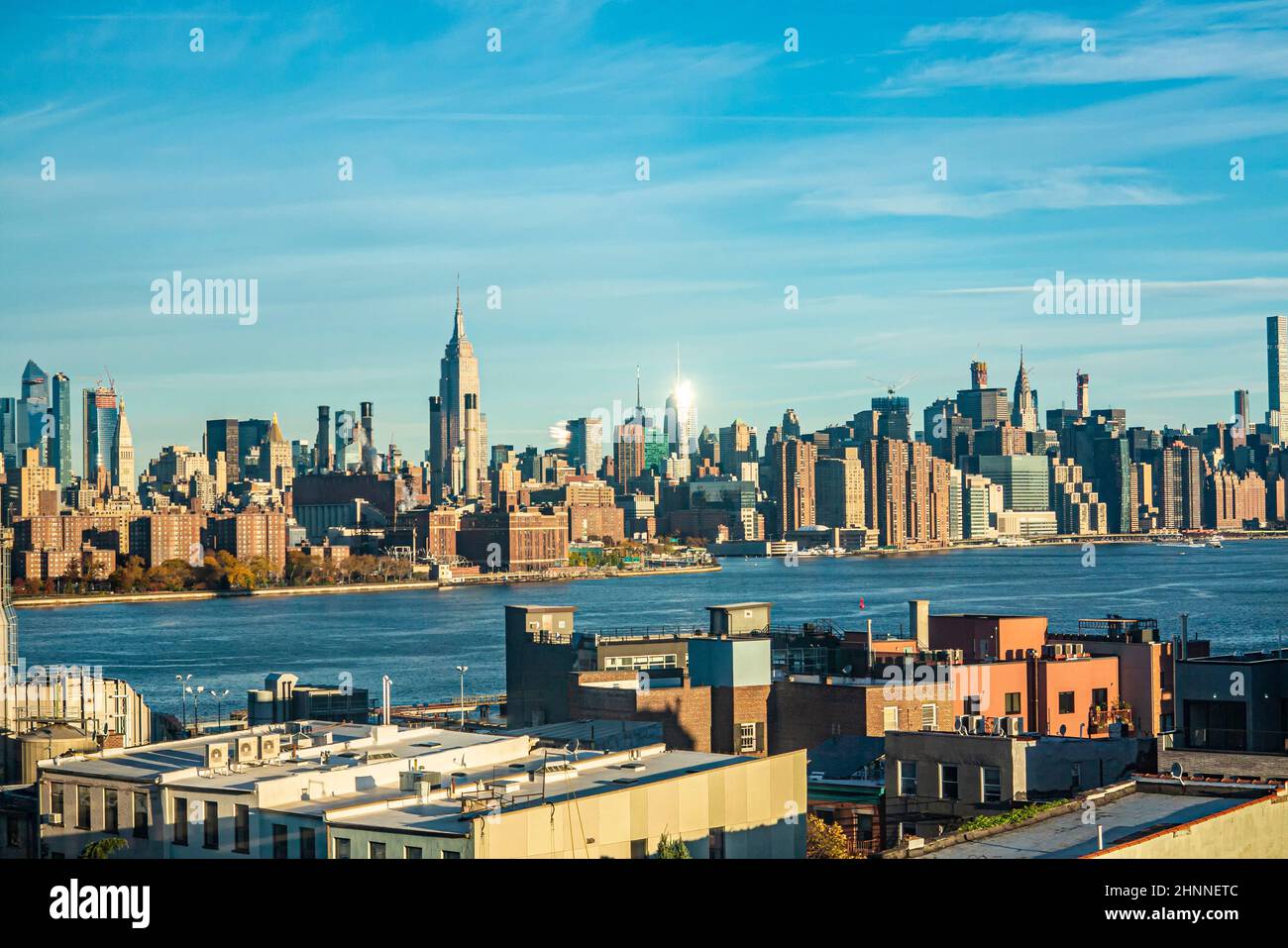 view to skyline of Manhattan from the brooklyn side with river Hudson in sunset Stock Photo