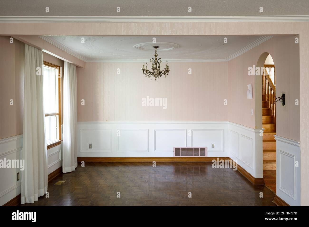 A vintage 1950s dining room with a stucco decorative ceiling. Stock Photo