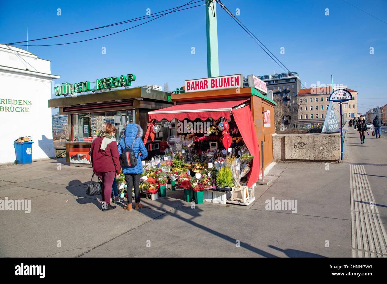 flower shop an a sausage food stall  at the Friedensbruecke (peace bridge) in Vienna, Austria, People enjoy buying at these small kiosks Stock Photo