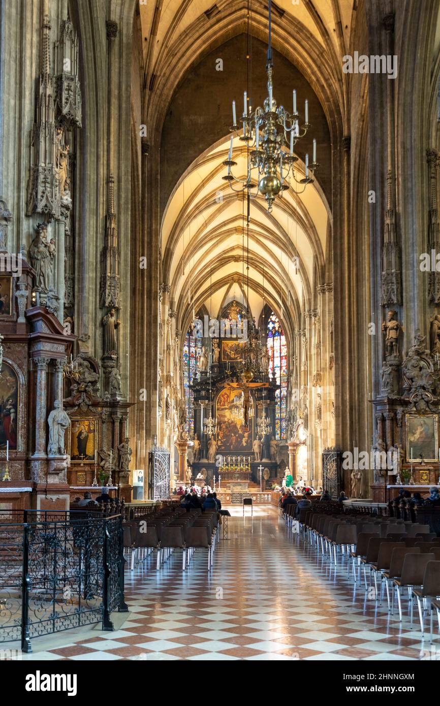 people take part at religious service for catholics in St. Stephens cathedral in Vienna. Stock Photo
