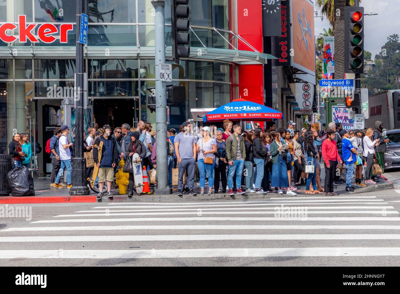 People At A Pedestrian Crossing Wait For Green Light On Hollywood People at a pedestrian crossing wait for green light on hollywood