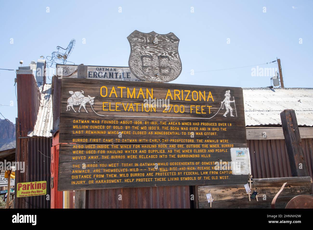 entrance sign of Oatman at Route 66. The sign explains the role of the Mules in the village of Oatman. Stock Photo