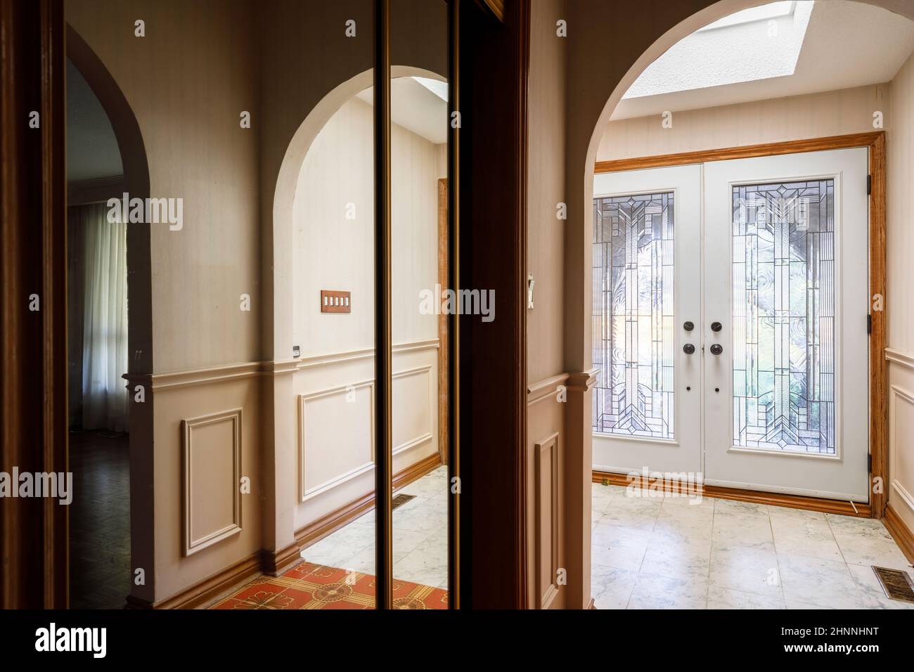 An entryway to a home, with a skylight above the door. Stock Photo