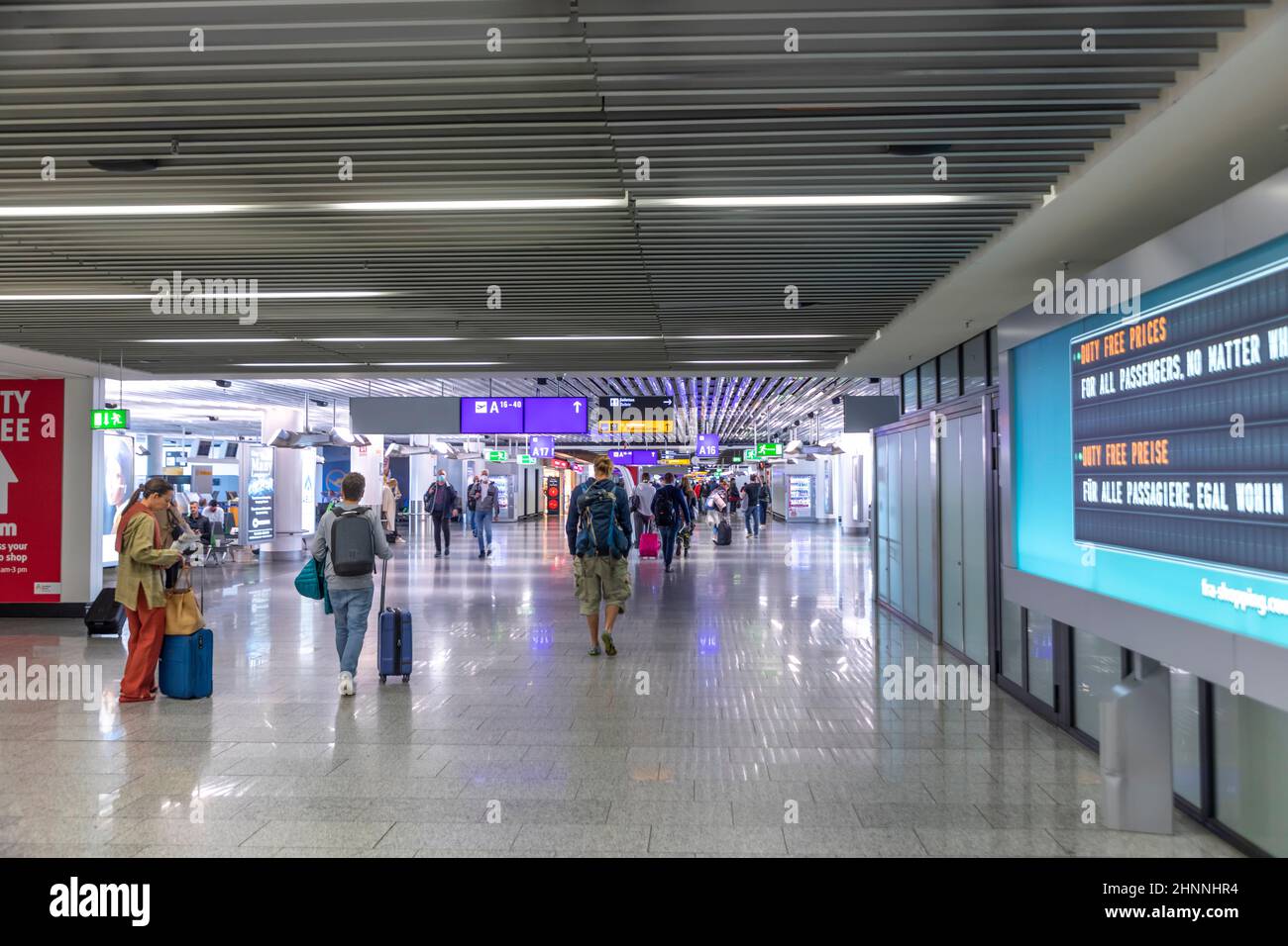 people at Frankfurt airport with distance around 2 meters  due to corona at Frankfurt Airport. Stock Photo