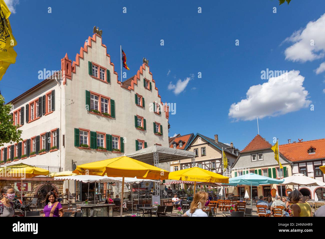 people enjoy a summer day at Market Place of Oppenheim, Germany during the corona season. Stock Photo