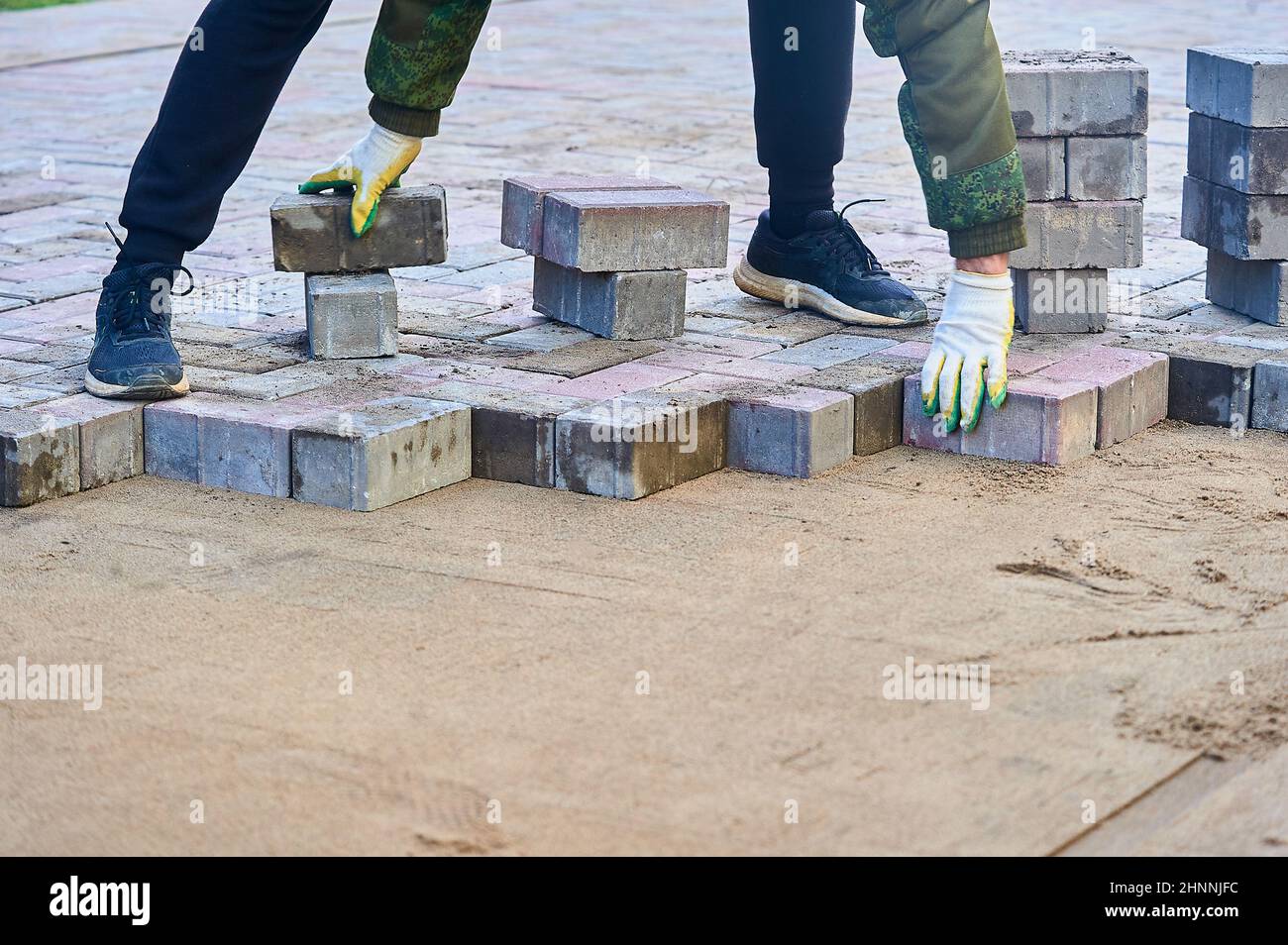laying paving slabs on the sand with your hands Stock Photo Alamy