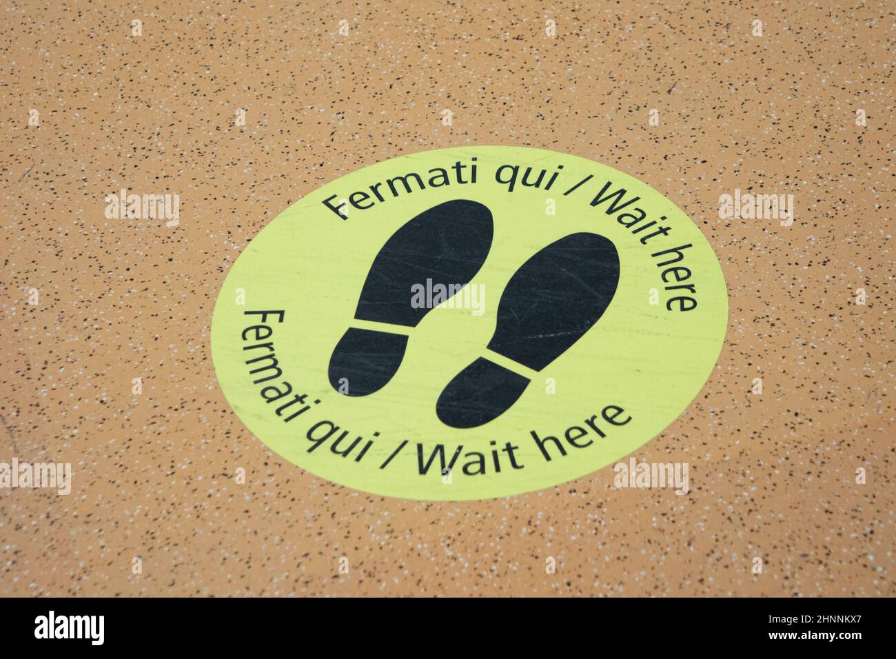 symbol for waiting and keeping distance at the floor in the Venice Airport Marco Polo Stock Photo