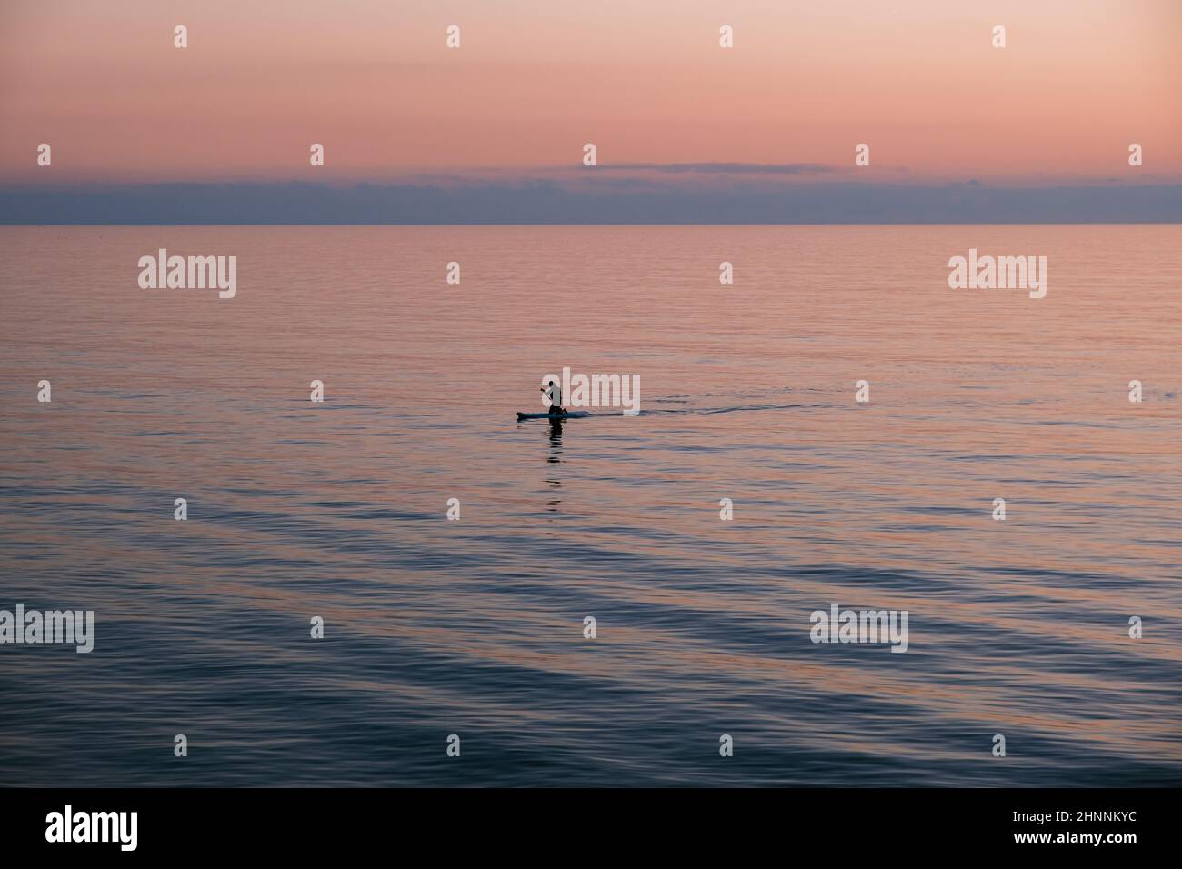 Man on canoe in the middle of the sea Stock Photo - Alamy