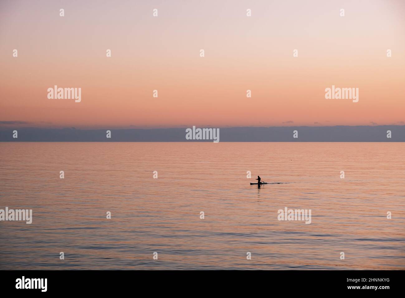 Man on canoe in the middle of the sea Stock Photo - Alamy