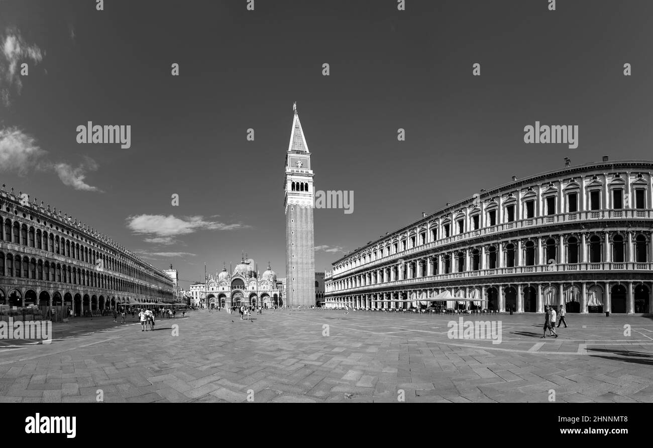 people enjoy visiting san Marco square with campanile and basilica in Venice, Italy. Stock Photo