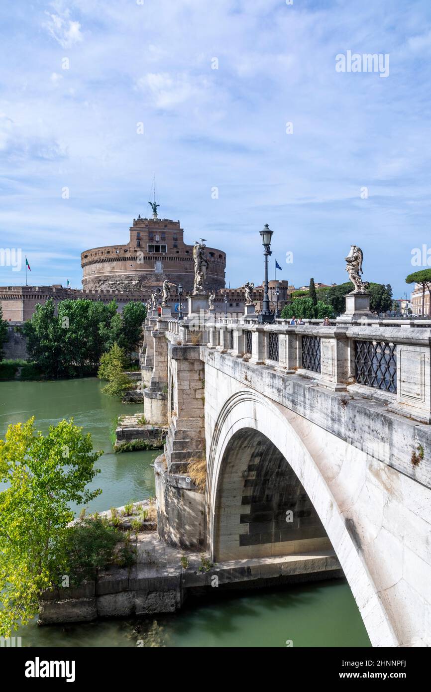 people enjoy visiting the castle of the holy angel in Rome by crossing the river Tiber at the bridge of holy angels in Rome, Italy. Stock Photo
