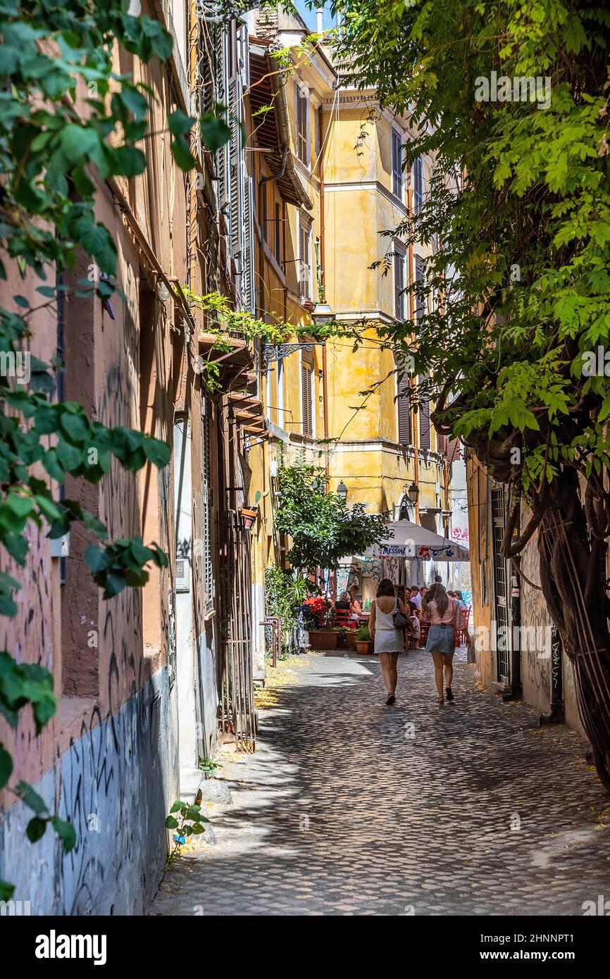 people enjoy the restaurants in the small roads in the quarter of Trastevere in Rome, Italy Stock Photo