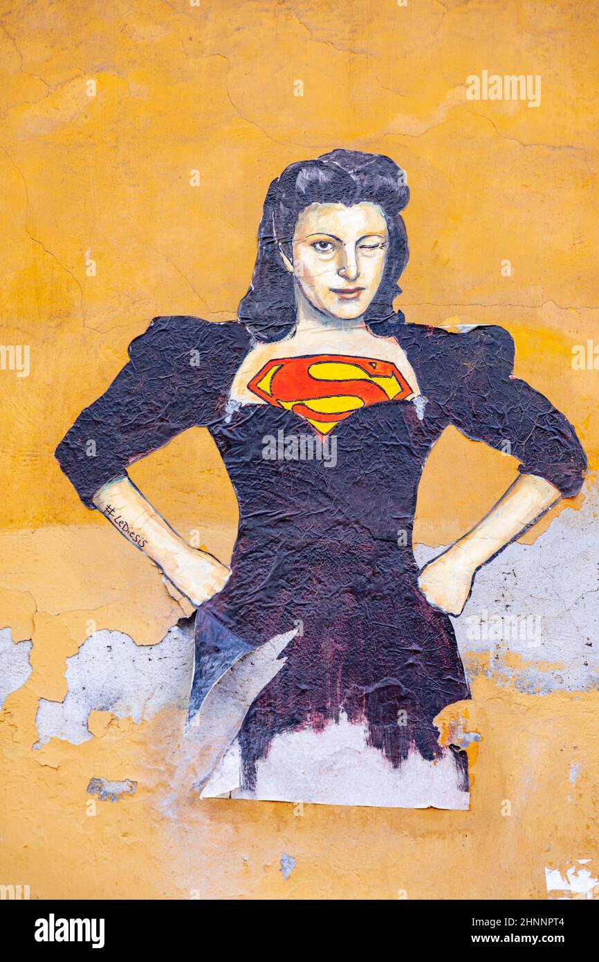 poster and additional painting of super woman at a house wall in roman quarter Trastevere Stock Photo