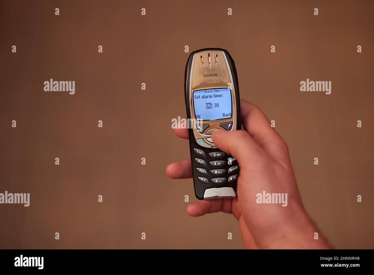 Setting alarm on old cellphone, Nokia 6310i Stock Photo