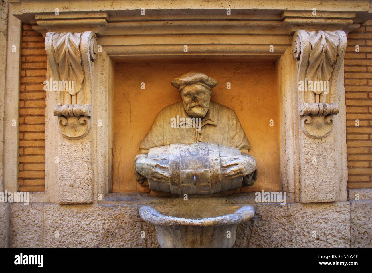 ROME, ITALY - December 28, 2018: Statue of an old man pouring water from a barrel used as a fountain nicknamed 'The Porter'. It was made in 1580 and used as a site to post satirical writings. Stock Photo