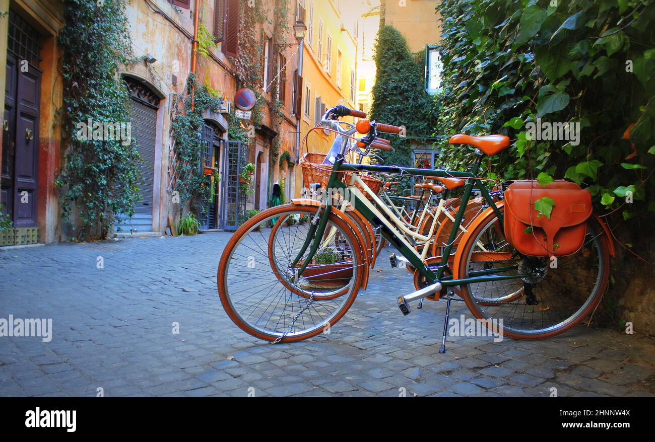 Bicycle standing in front of store on old street of Rome . Stock Photo