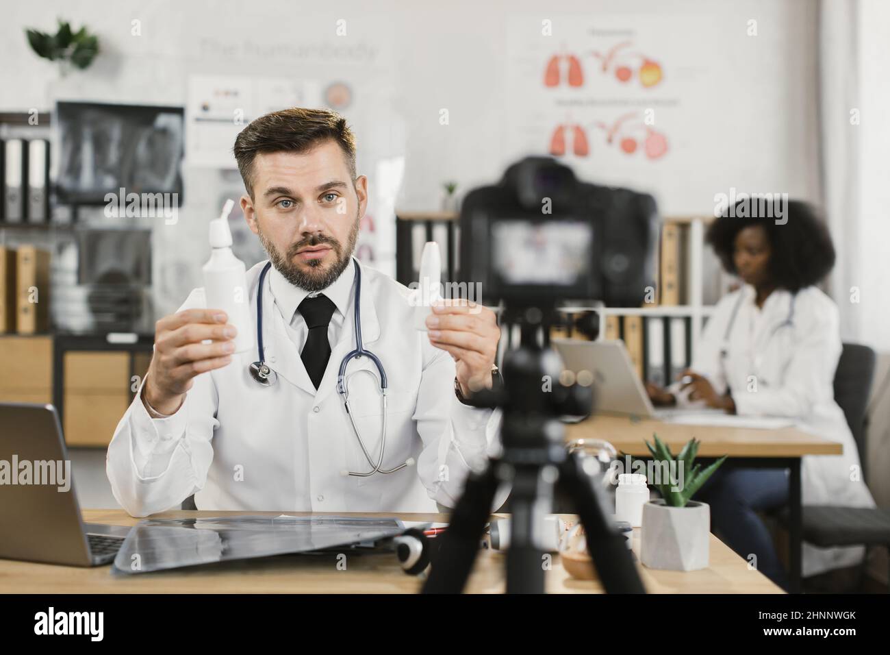 Doctor presenting vitamins talking camera hi-res stock photography and ...