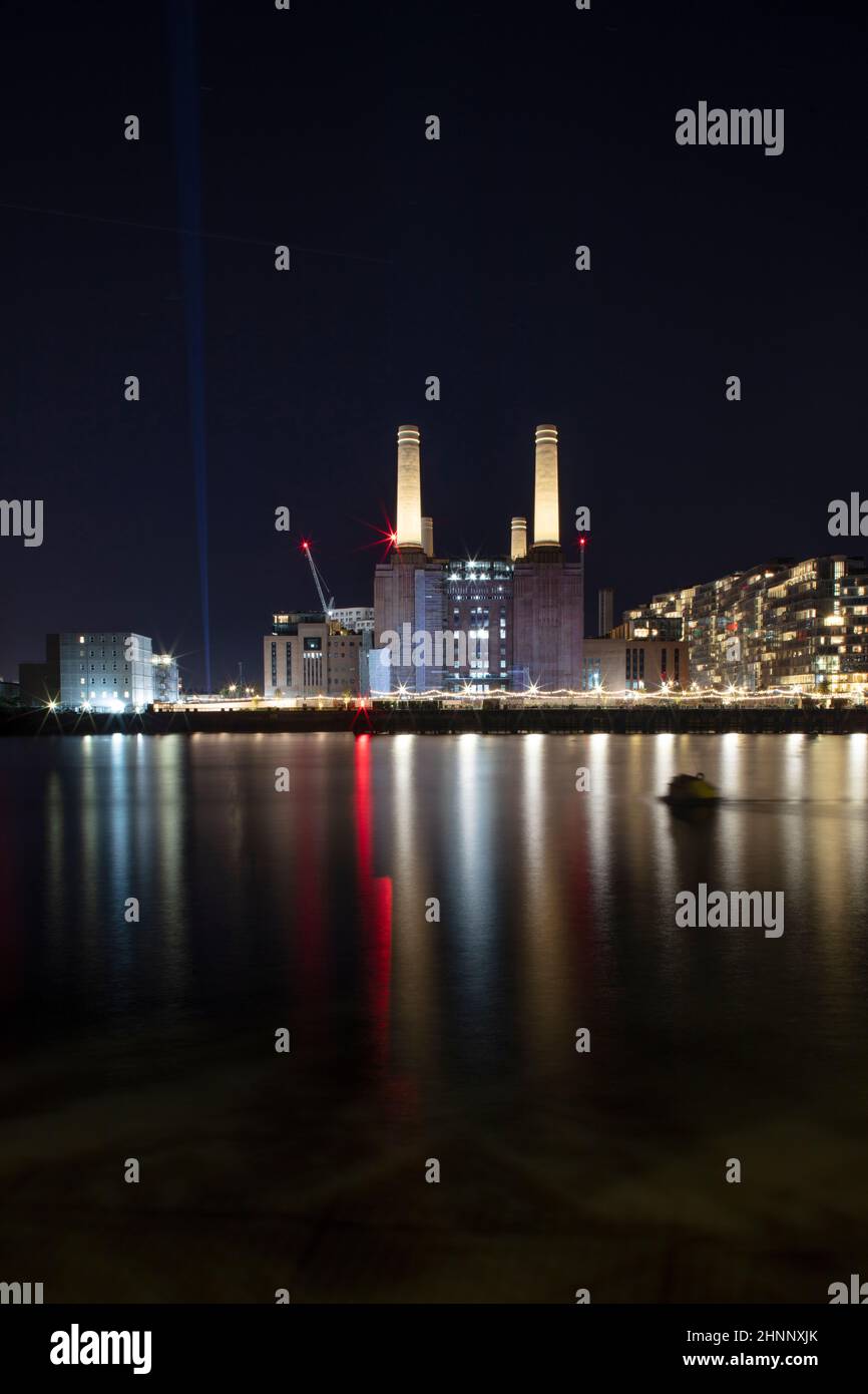 Battersea Power Station at night, with the Thames river in the foreground, copy space, no people, London SW8 5BN Stock Photo